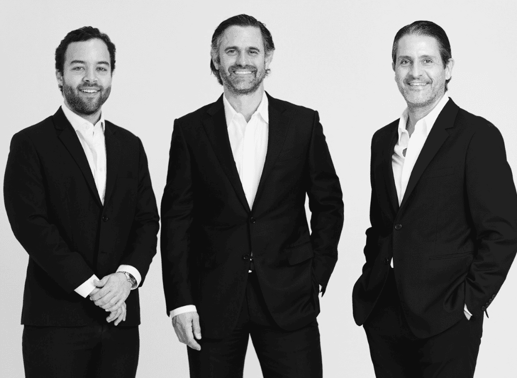 Managing partners of WD Capital Group standing together in formal business attire.