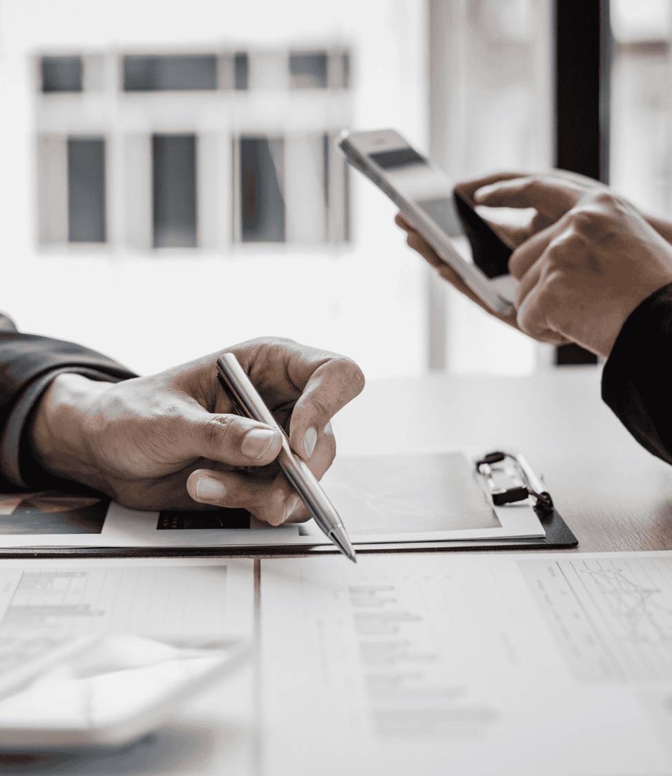 WD Capital Group team reviewing documents and financial data during a business meeting.